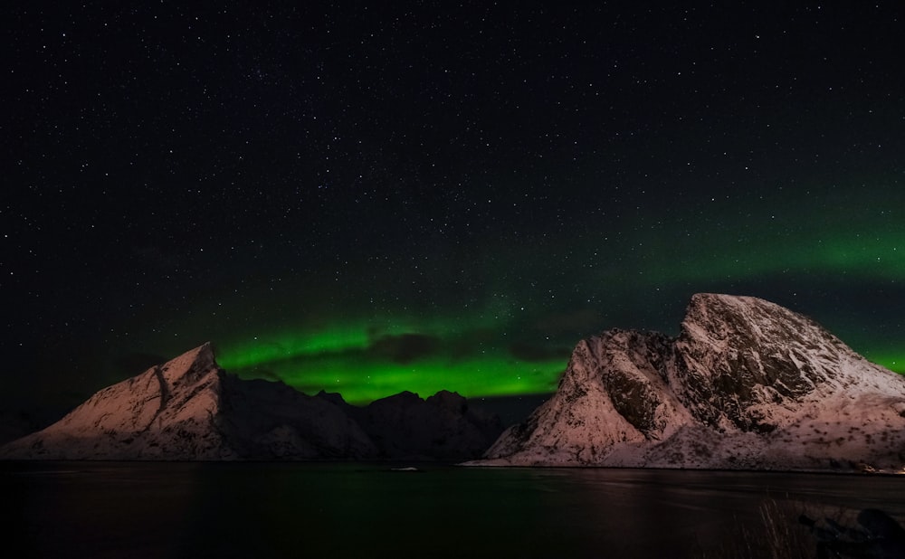 a mountain with a green light in the sky