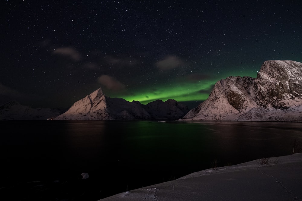 a mountain with a green light in the sky