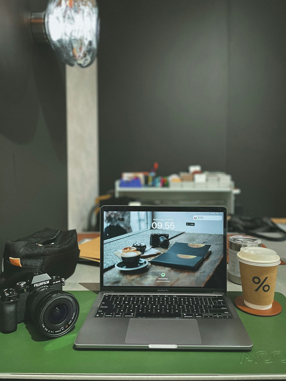 a laptop computer sitting on top of a green desk