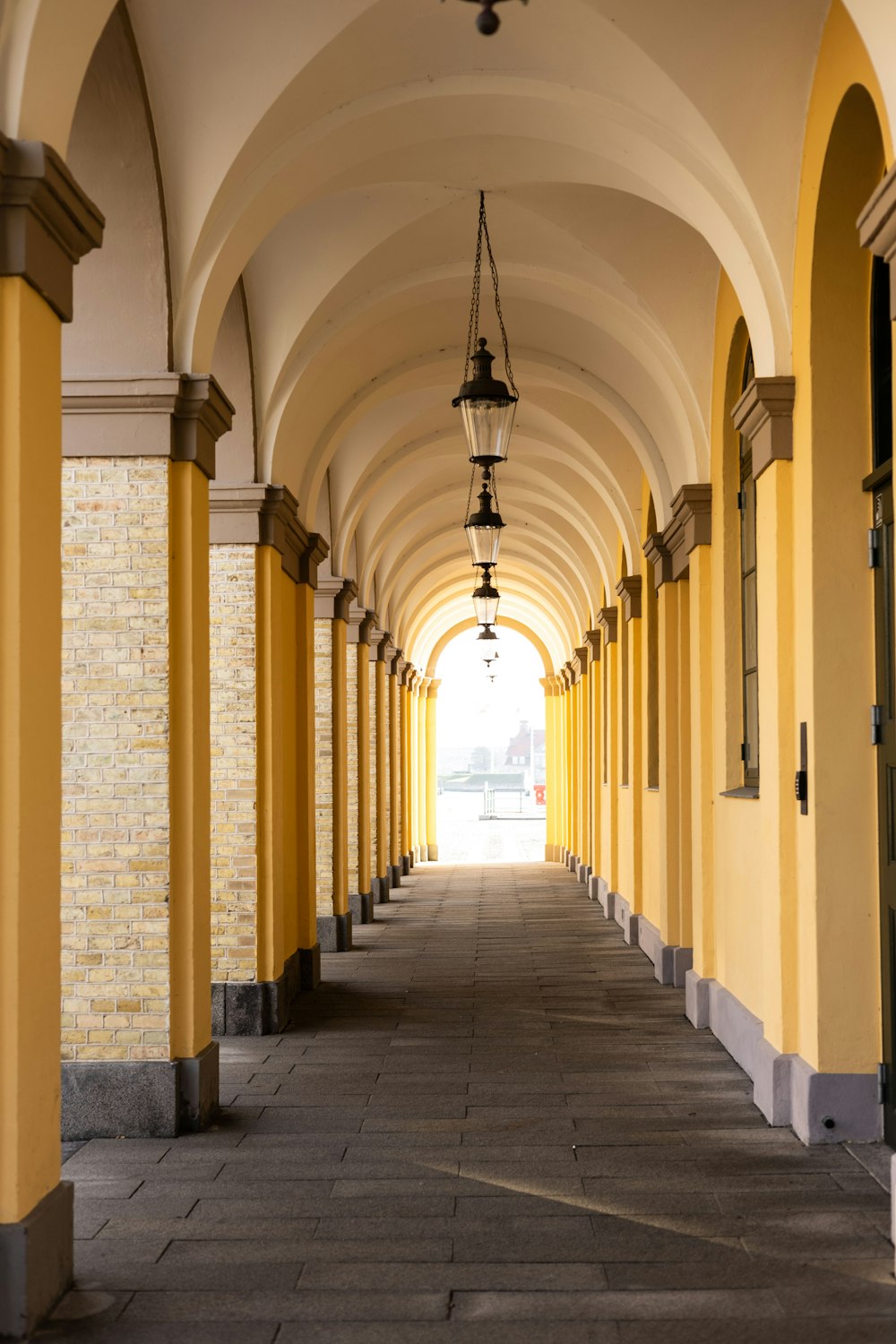 a row of yellow and white arches on a building