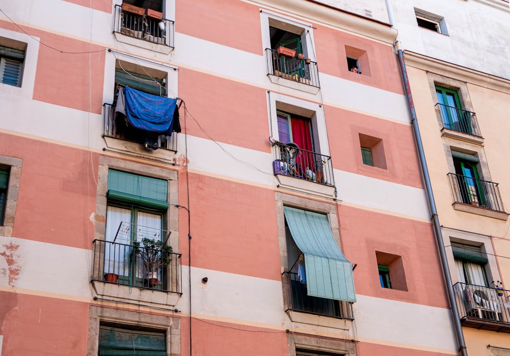 a tall building with lots of windows and balconies