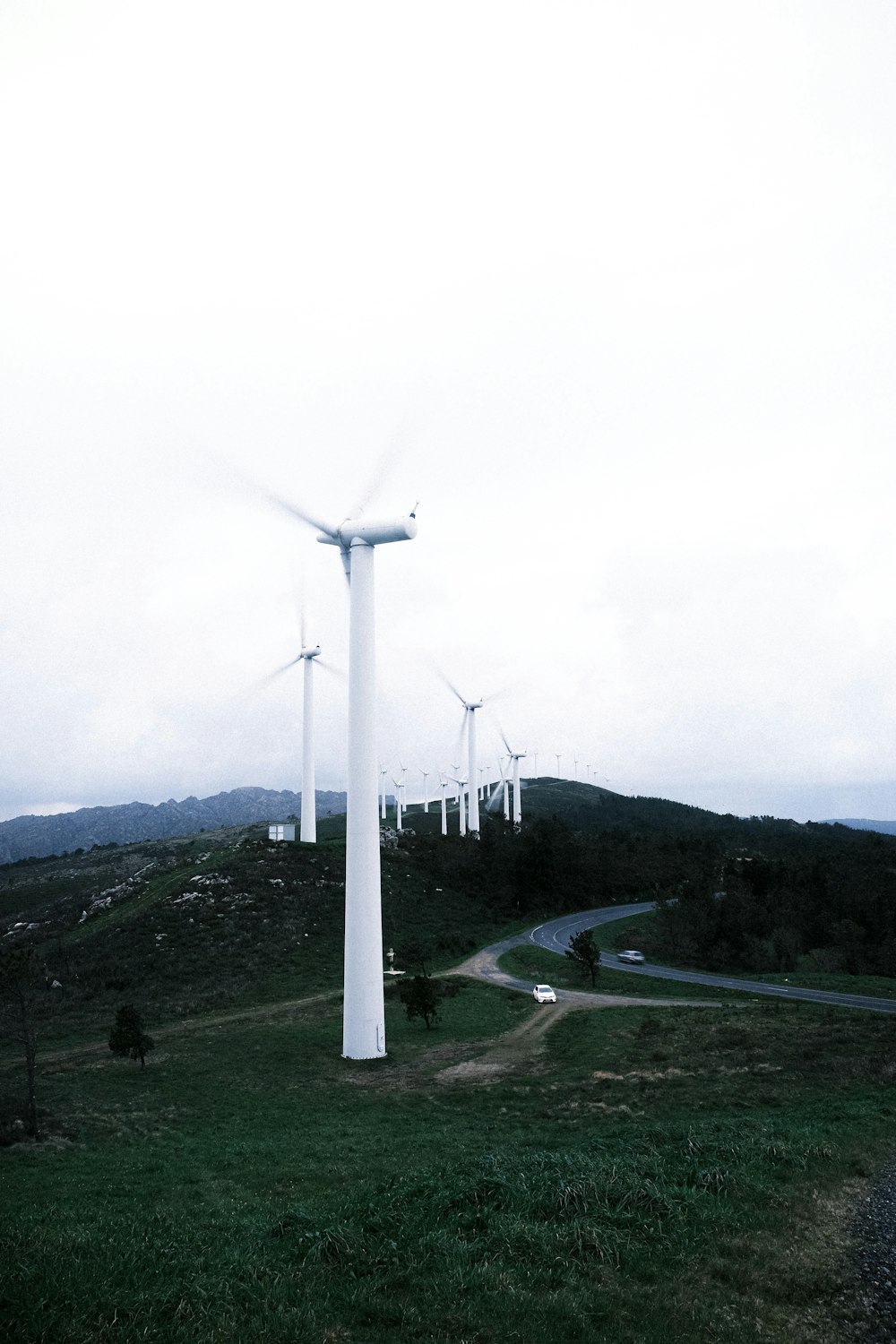 a group of wind turbines on a hill