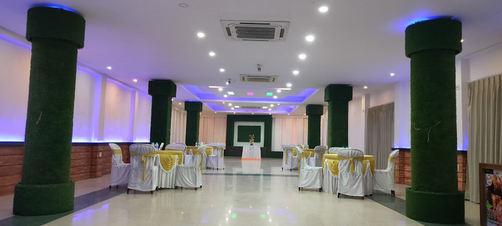 a banquet hall decorated with white and yellow linens