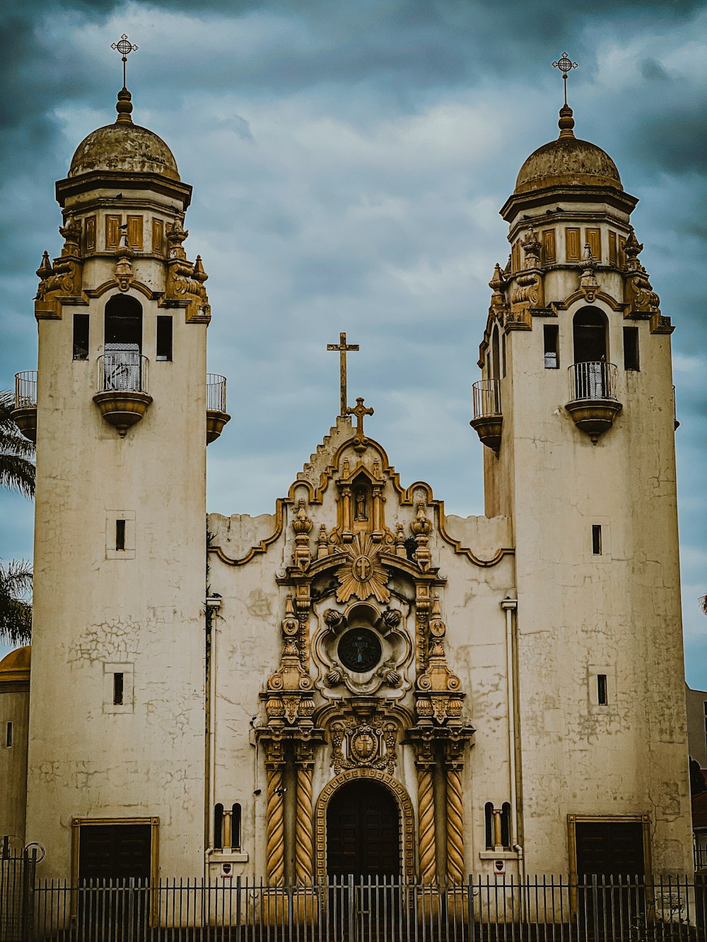 a church with two towers and a cross on top