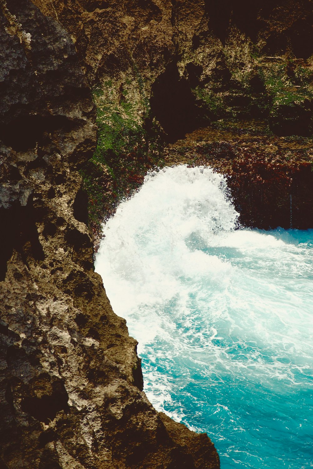 a man riding a surfboard on top of a wave in the ocean