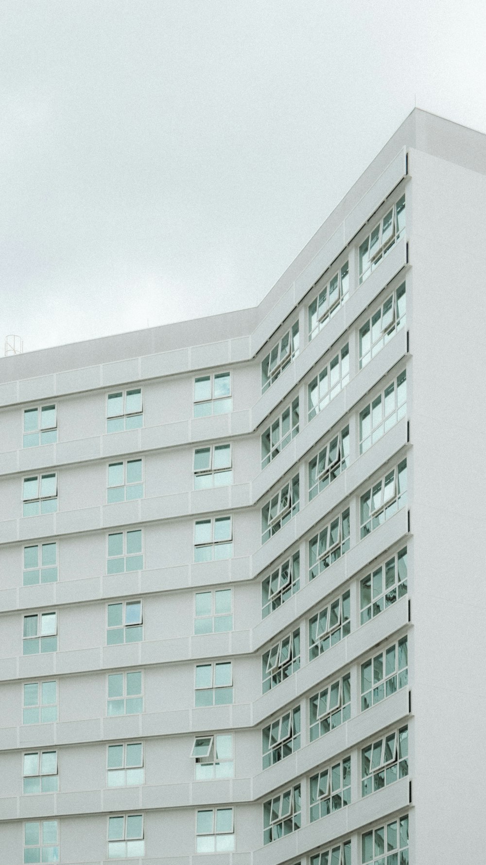 a large white building with a clock on it's side