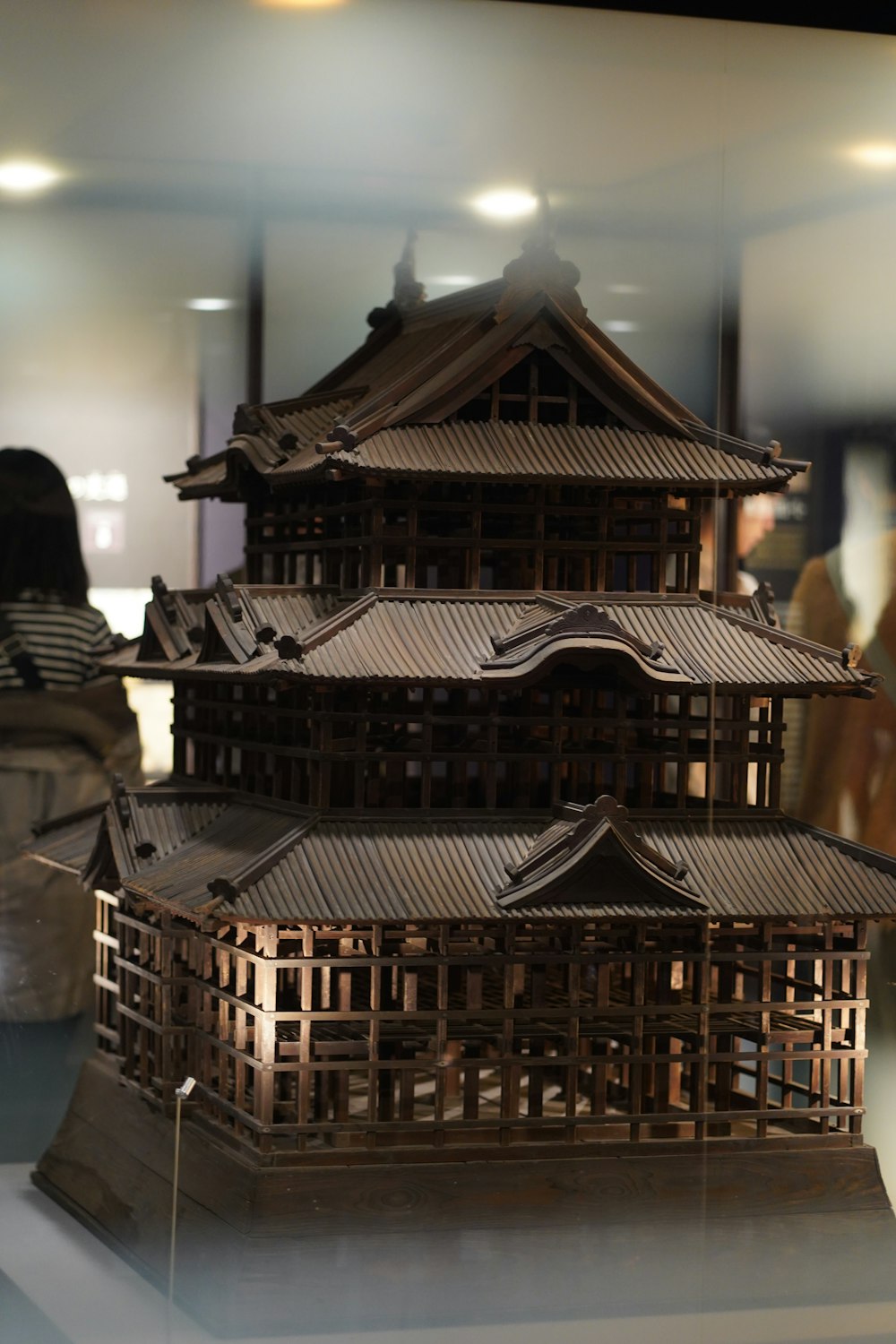 a wooden model of a building in a display case