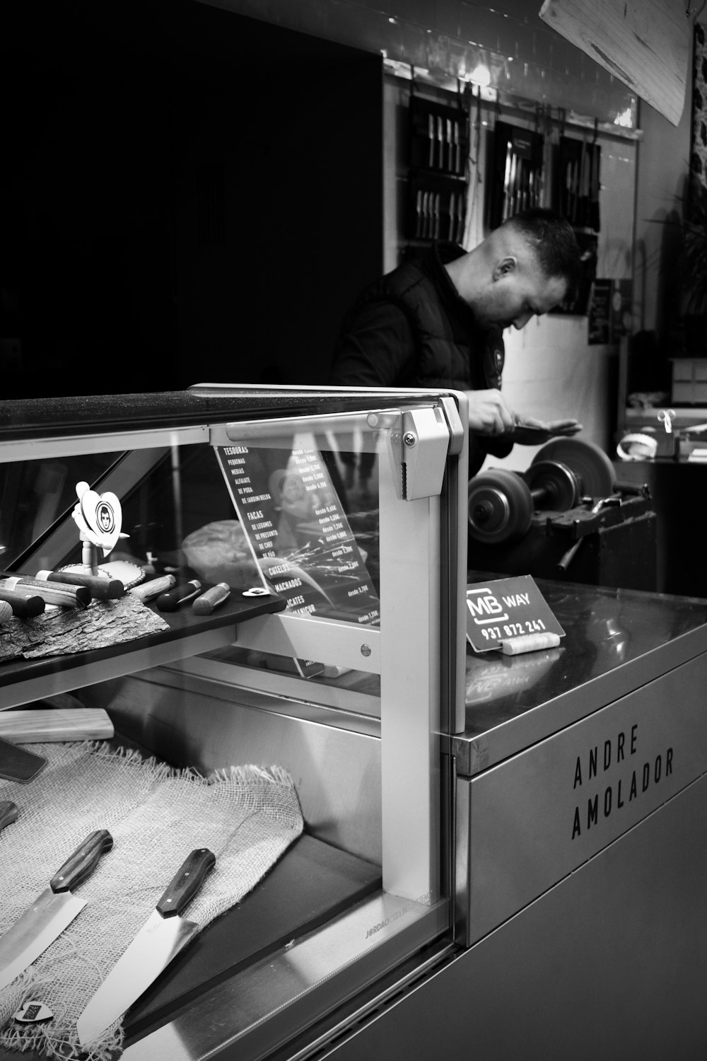 a black and white photo of a man working in a bakery