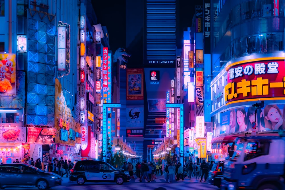 a busy city street at night with neon lights