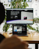 a person sitting in front of a computer screen