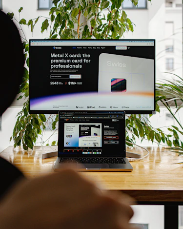 a person sitting in front of a computer screen