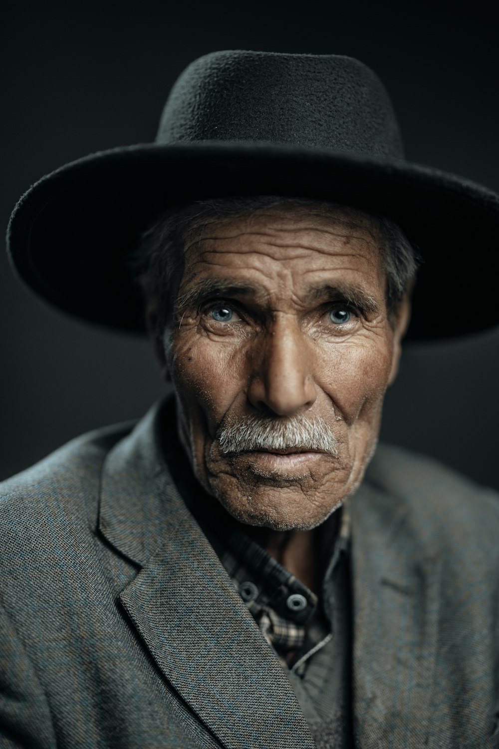 an old man with a mustache and a hat