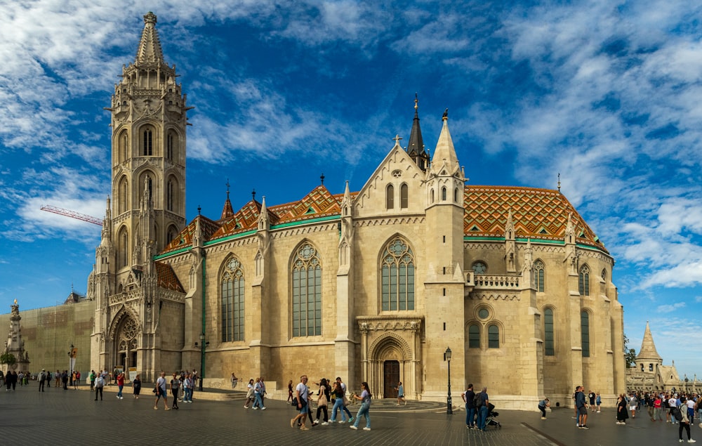 a group of people standing in front of a large building