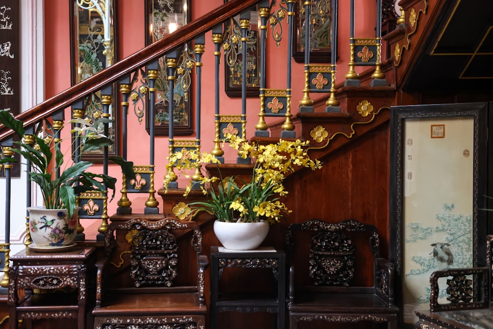 a stair case with a vase of flowers on top of it