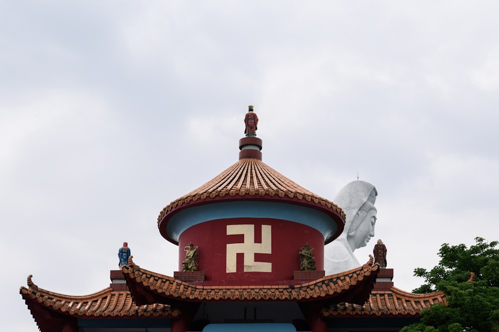 a red and blue building with a white bird on top of it