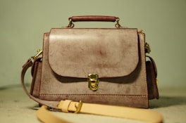 a brown purse sitting on top of a table