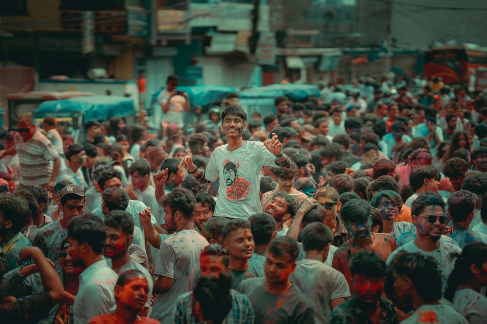 a crowd of people standing around each other