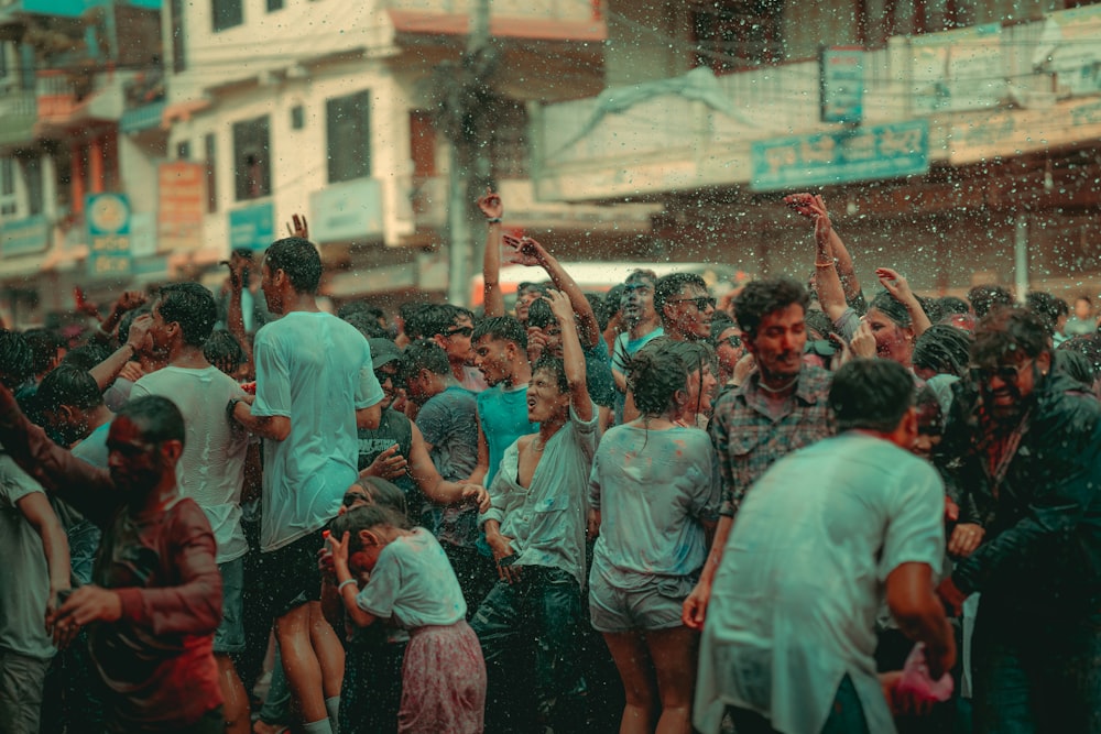 a crowd of people standing around each other