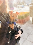 a woman holding a small dog in her arms