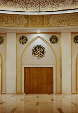a large room with a wooden door and two round windows