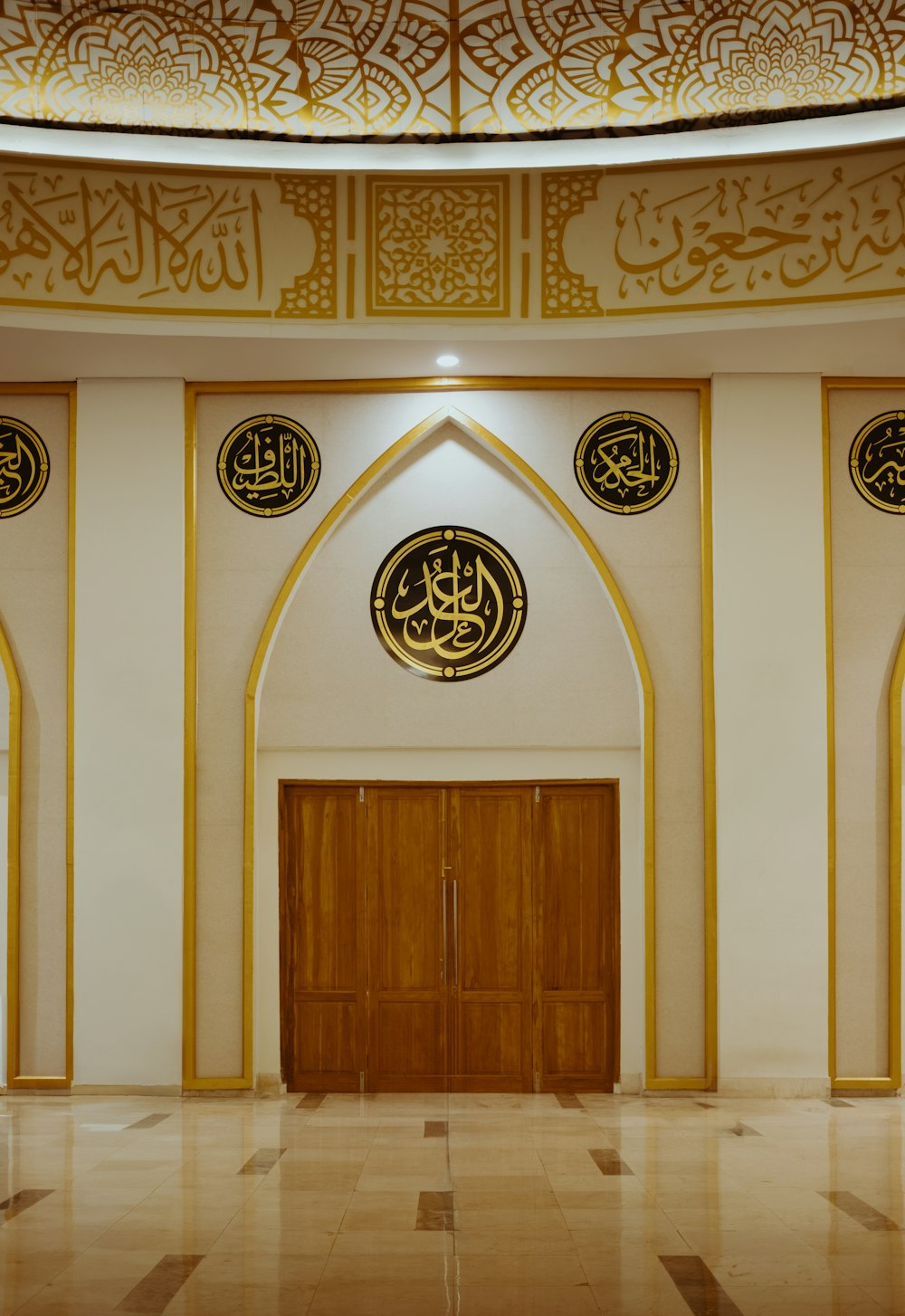 a large room with a wooden door and two round windows