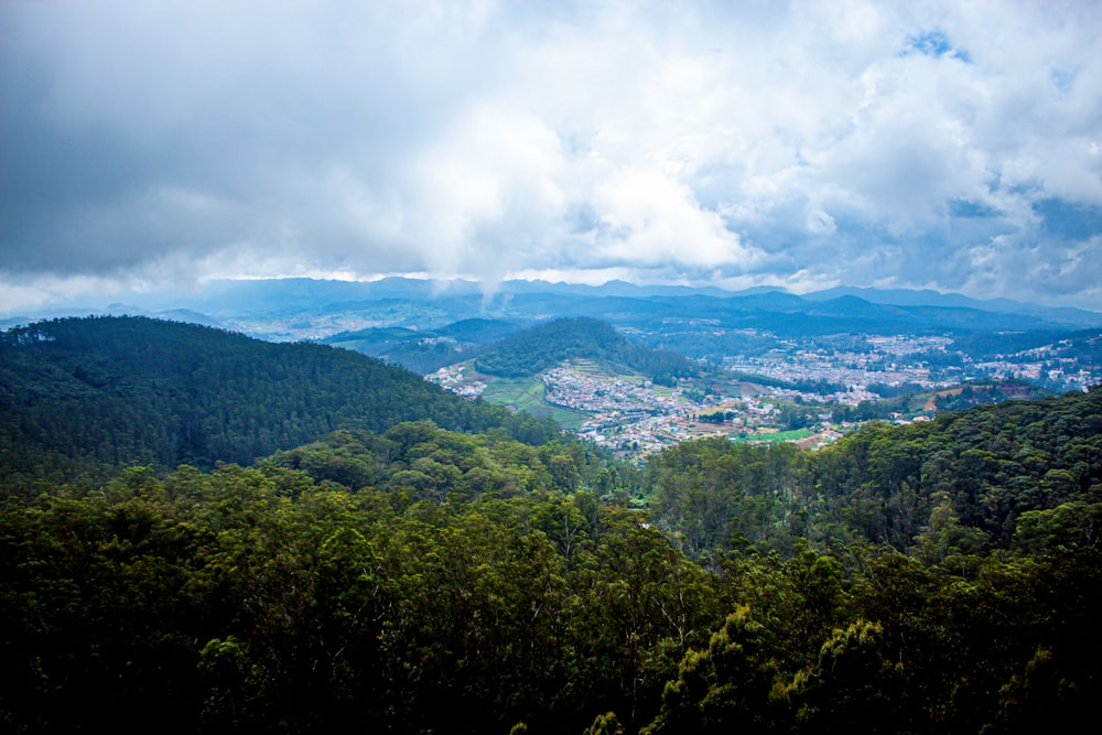 a scenic view of a city nestled in the mountains