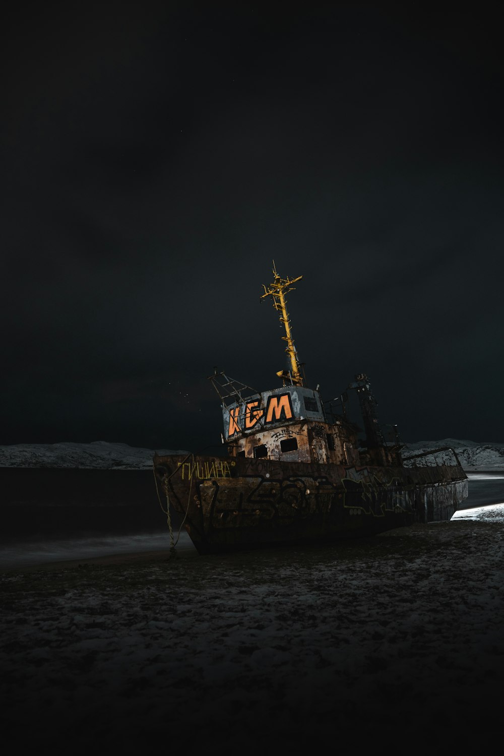 a boat sitting on top of a sandy beach