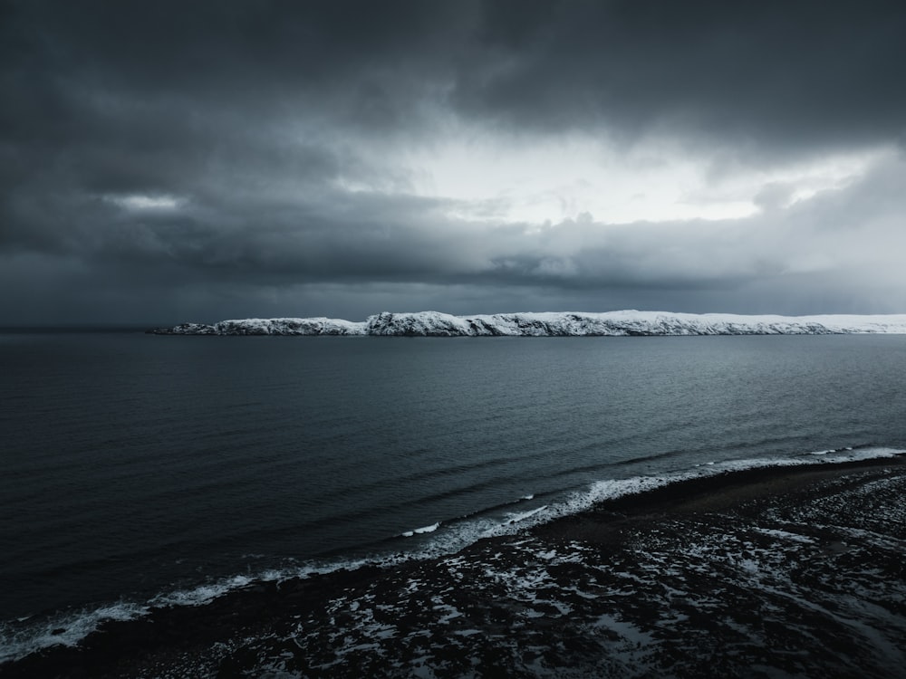 a large body of water under a cloudy sky