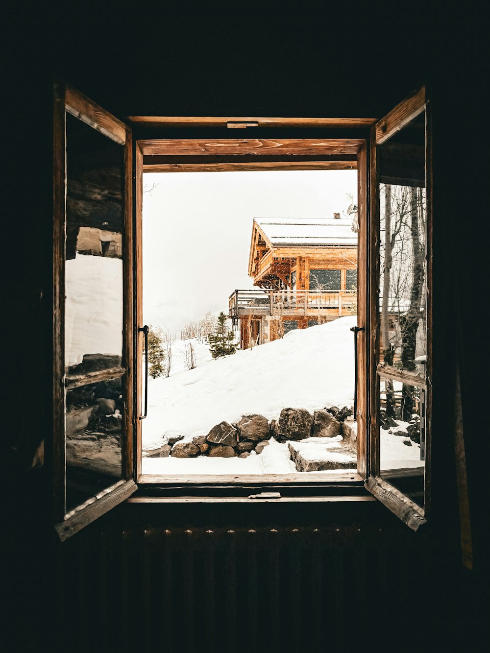 a window with a view of a snow covered mountain