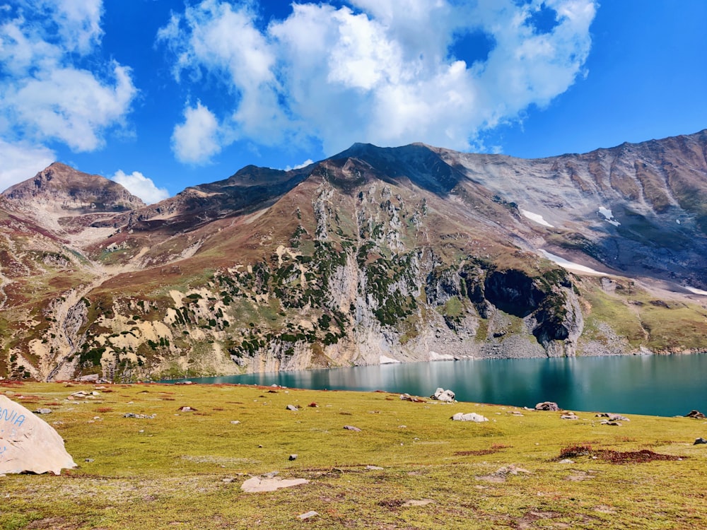 a mountain range with a lake in the foreground