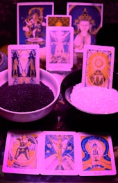 a table topped with cards and bowls filled with rice