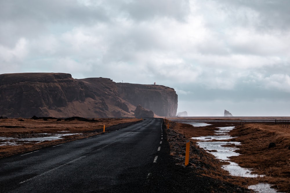 a road with a mountain in the background