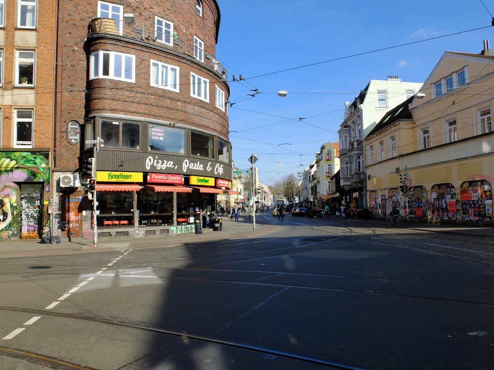 a city street with a large building on the corner