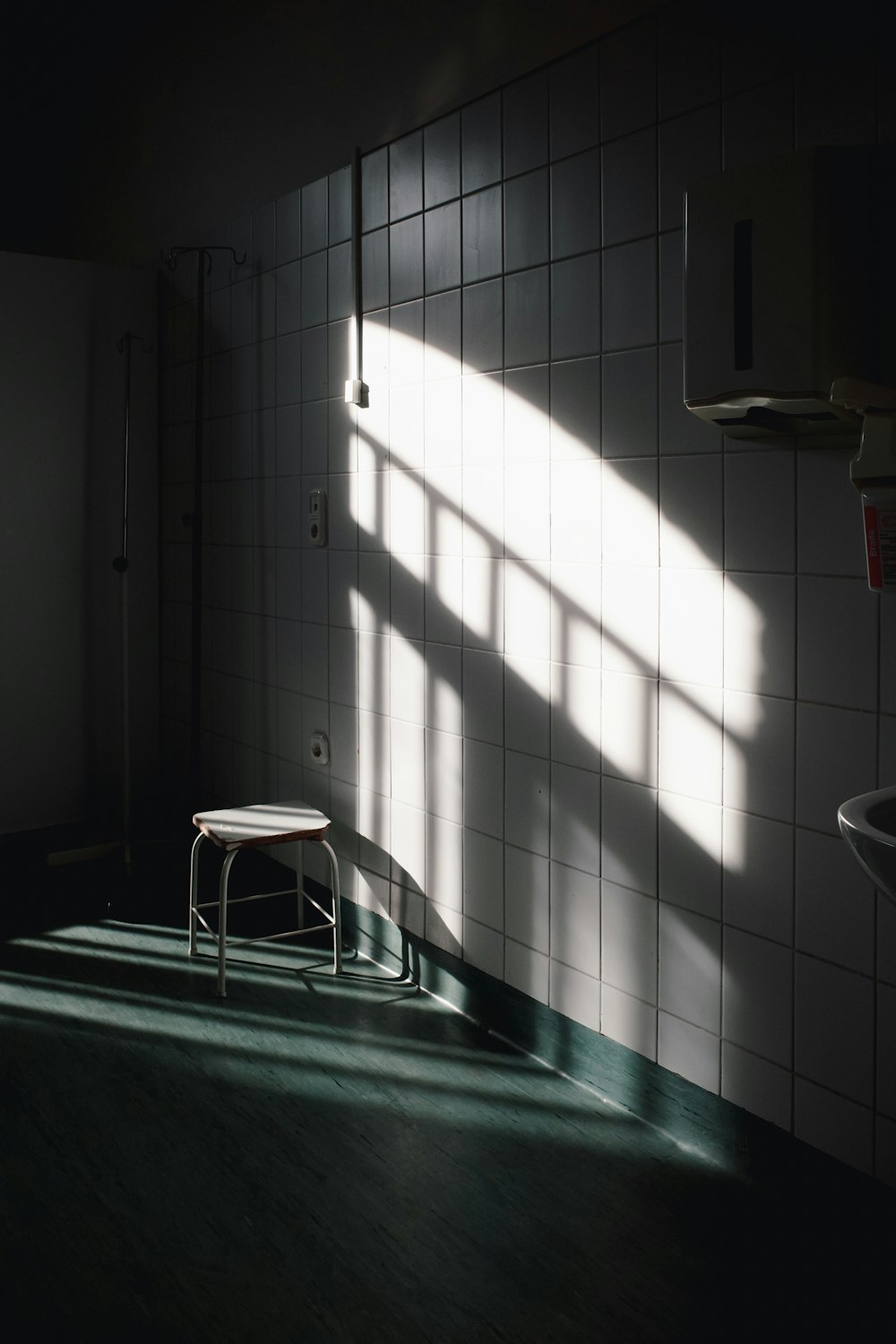 a chair sitting in a bathroom next to a window