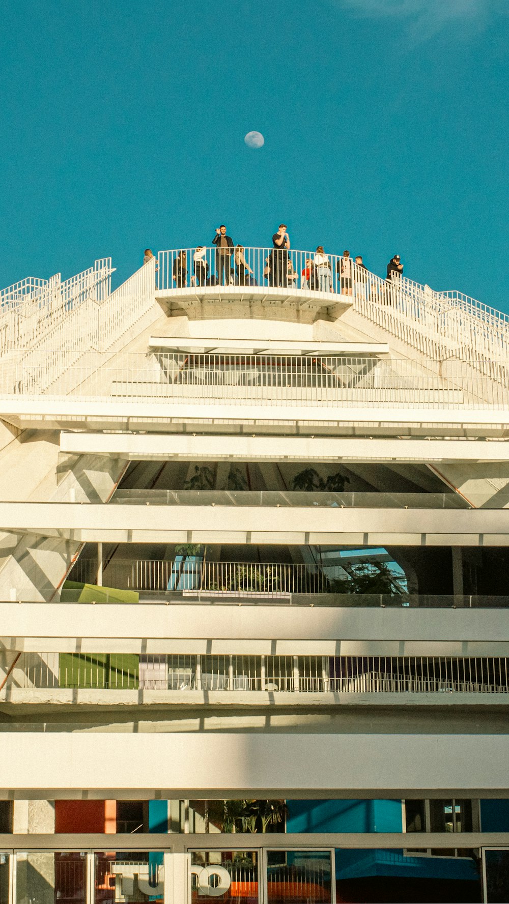 a group of people standing on top of a building