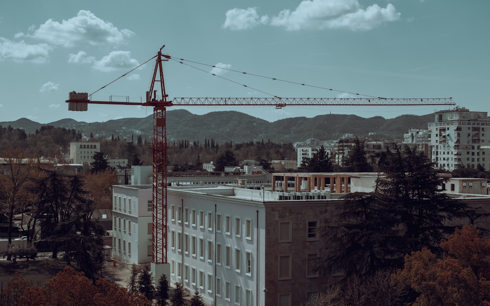 a crane is standing on top of a building