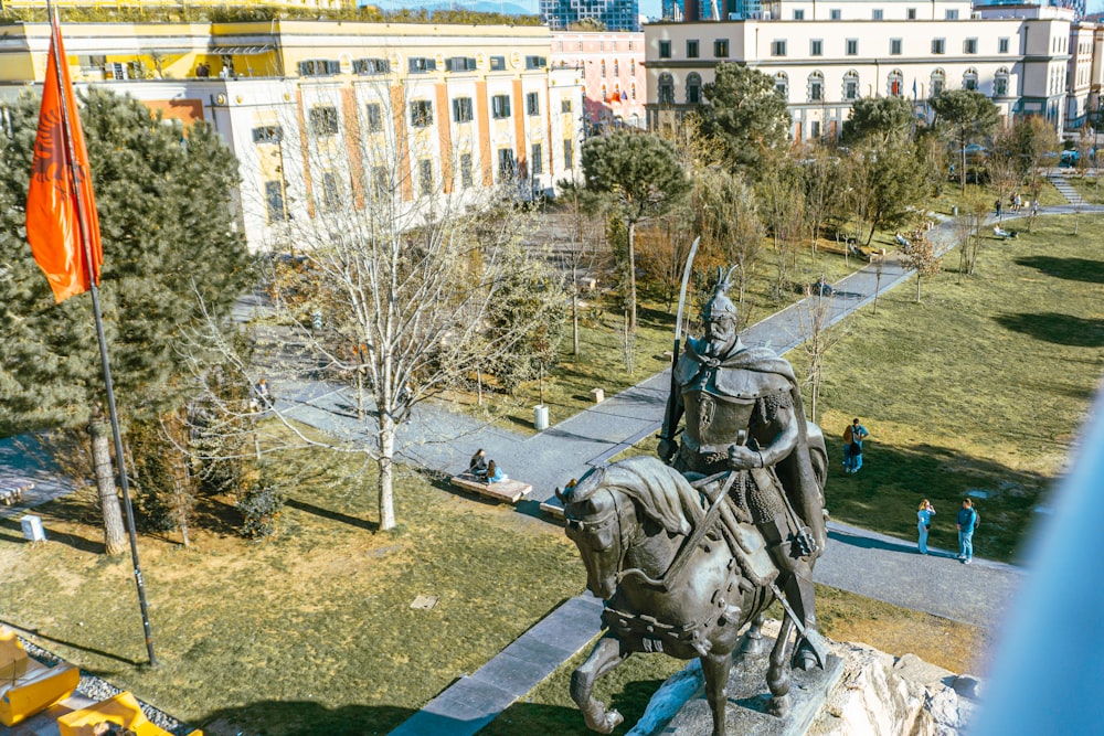 a statue of a man on a horse in a park