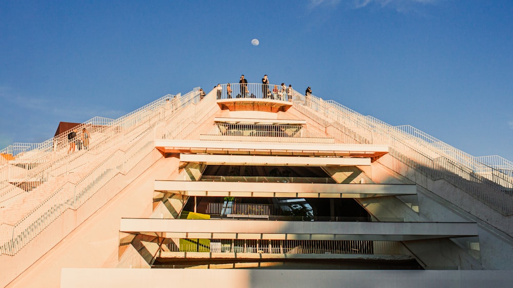 a group of people standing on top of a building