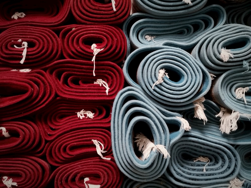 a pile of rolled up rugs sitting next to each other