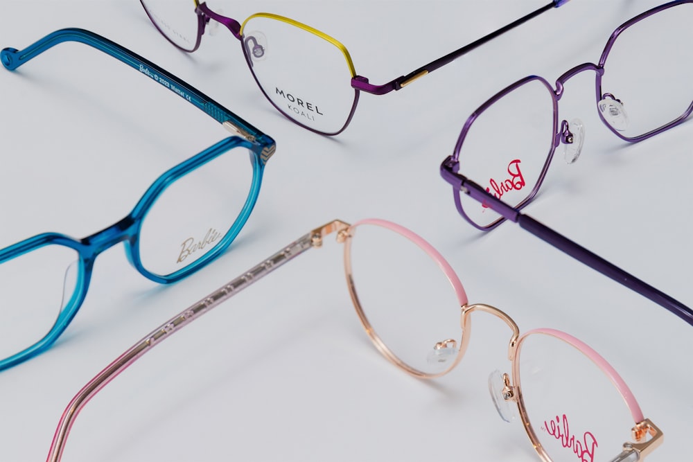 three pairs of glasses with the word barbie written on them