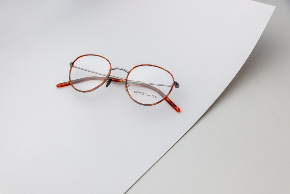 a pair of glasses sitting on top of a piece of paper