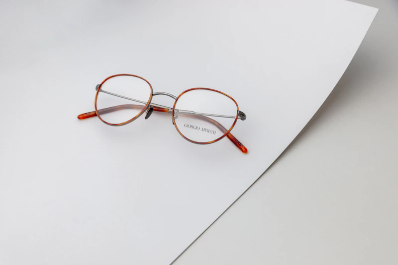 A pair of glasses on a sheet of paper