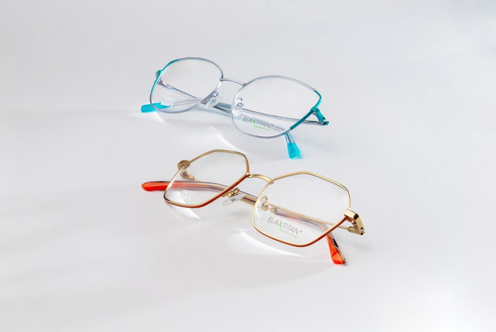a pair of glasses sitting on top of a white table