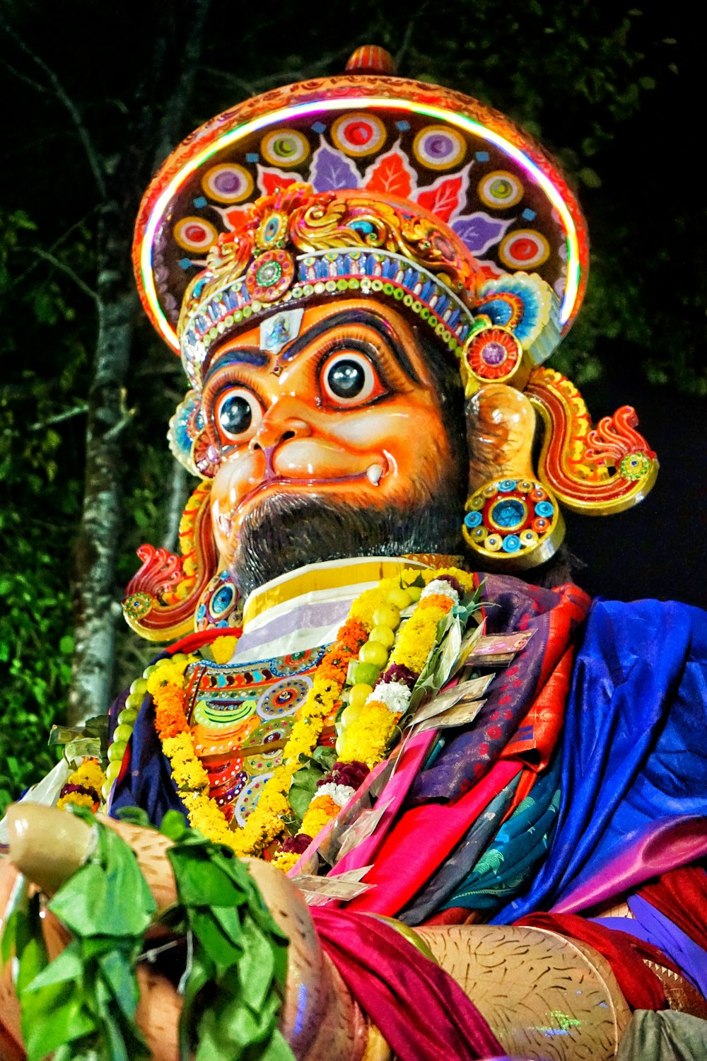 a statue of a man with a beard wearing a colorful headdress