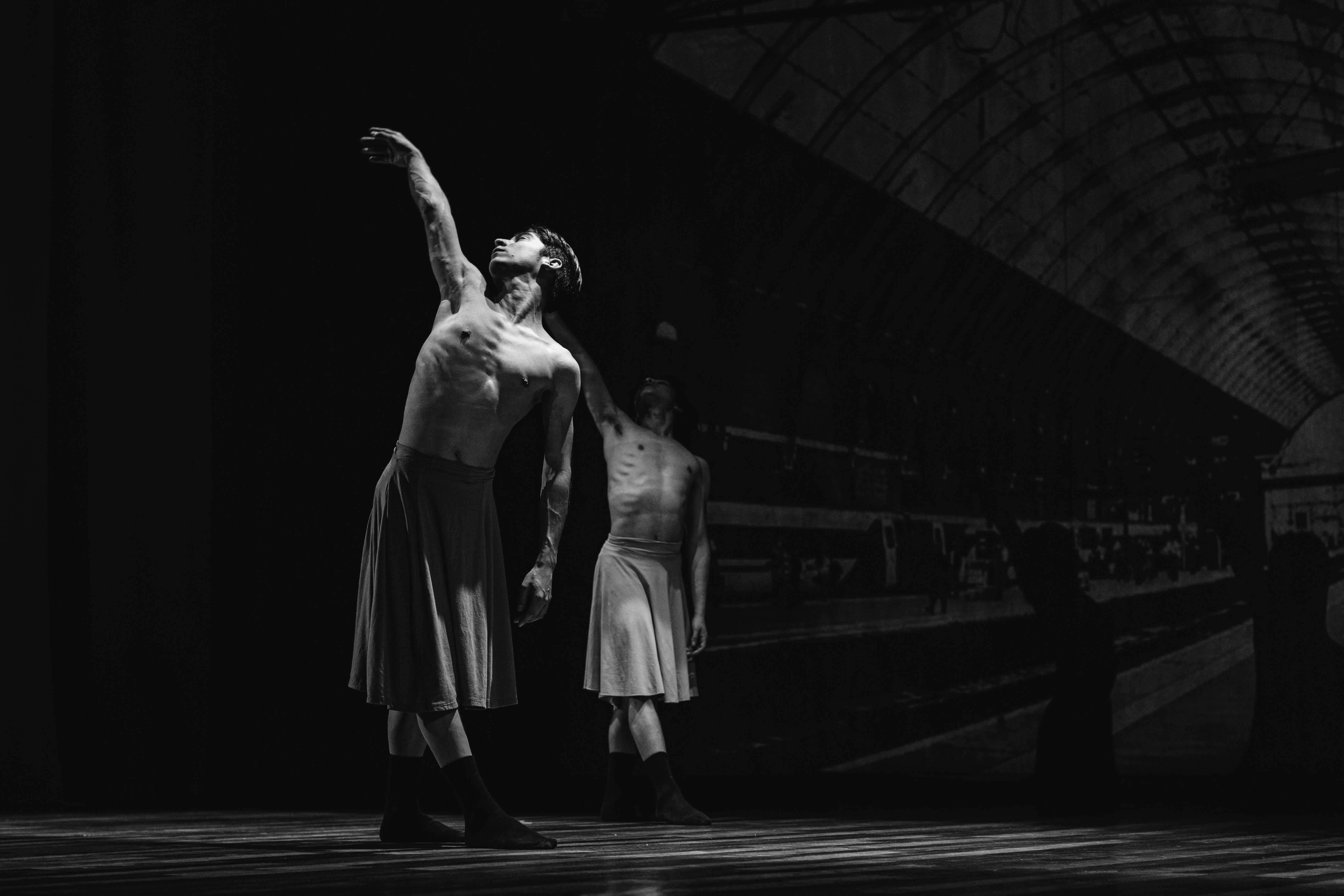 a couple of people that are standing in the dark