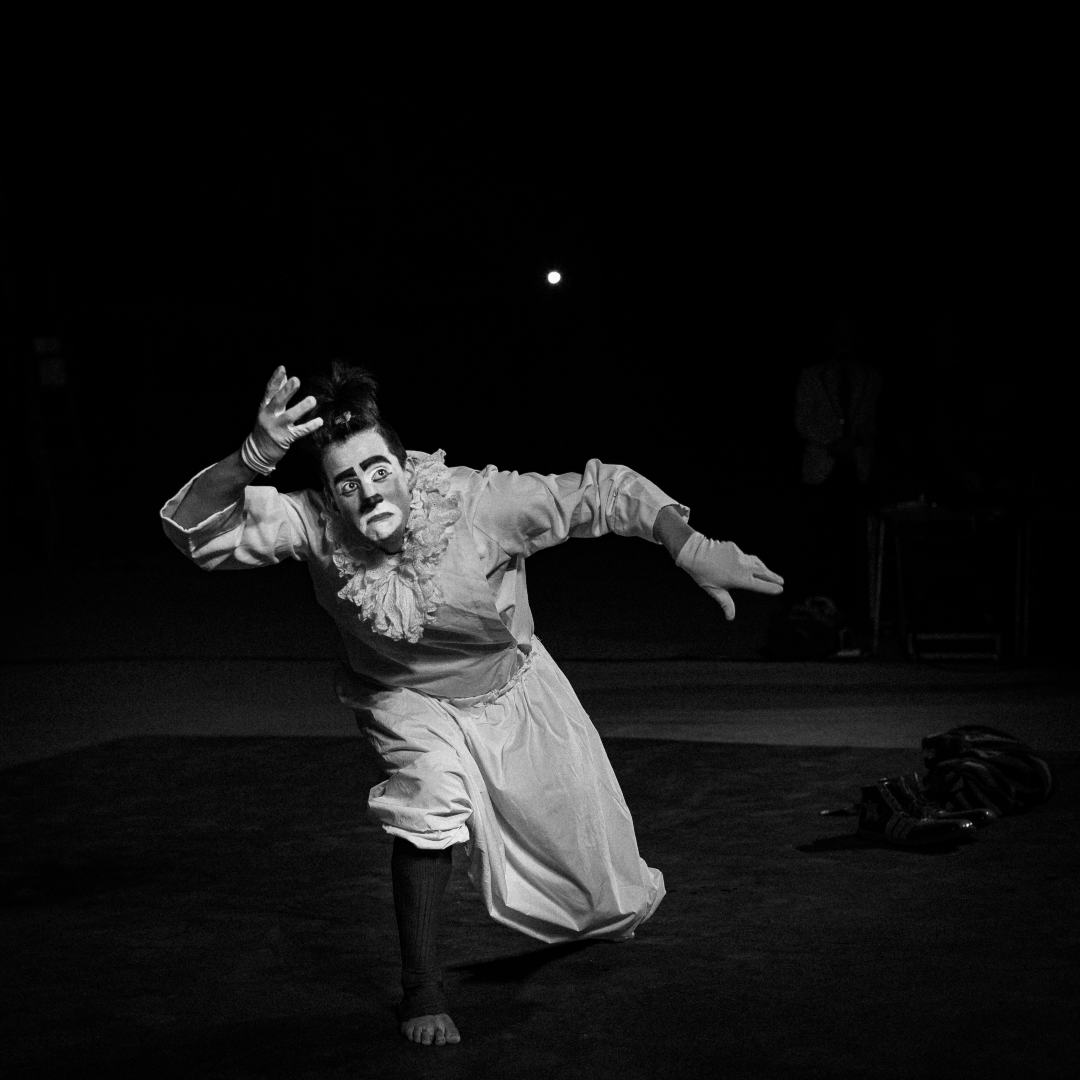 a man in a costume is dancing in the dark