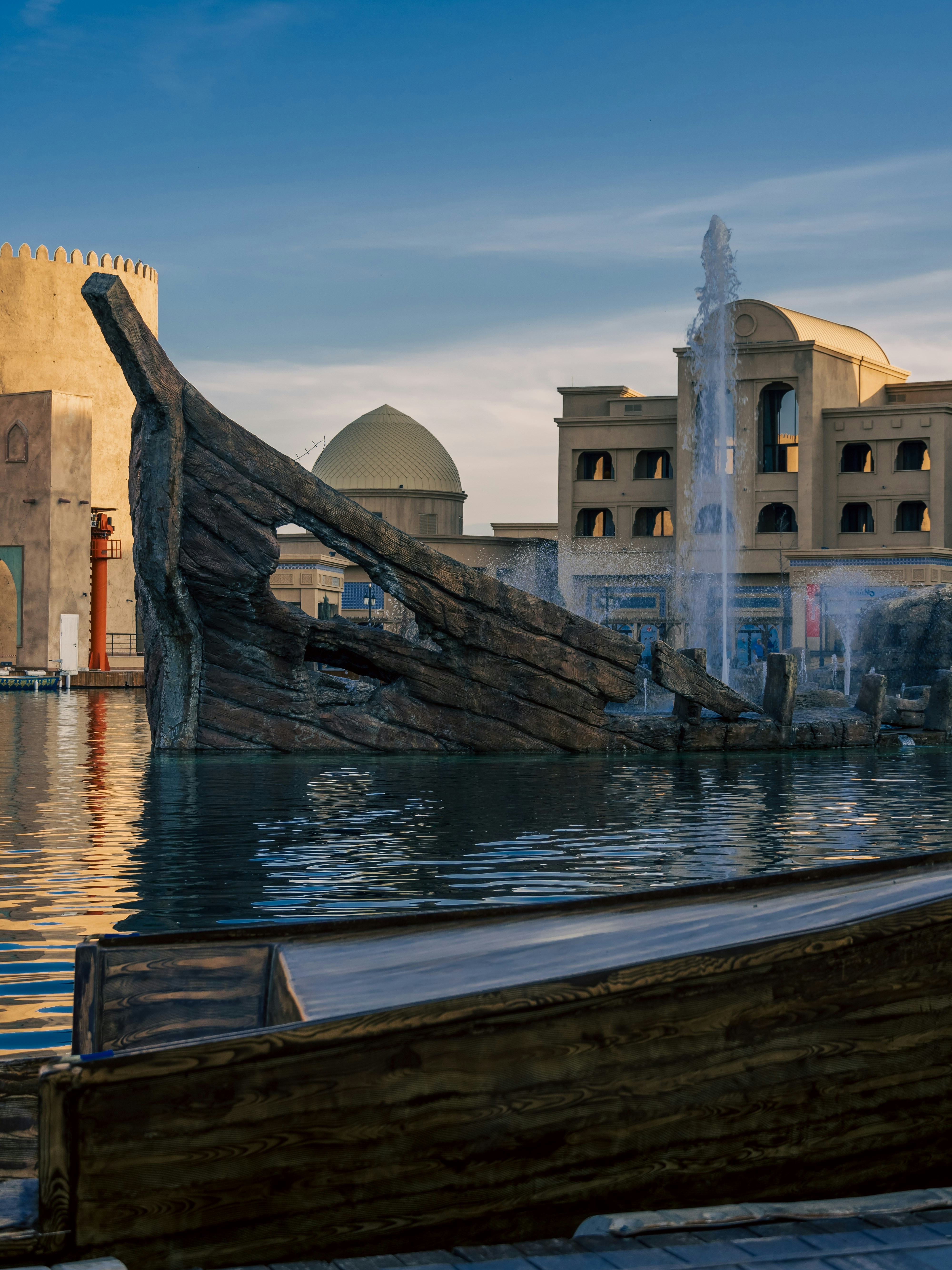 a large wooden boat sitting in the middle of a body of water