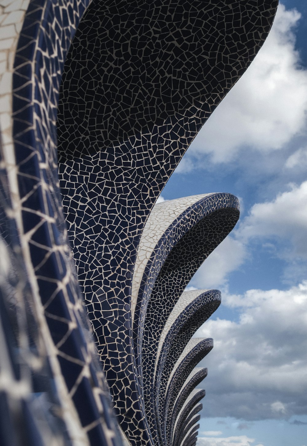a large sculpture with a sky background