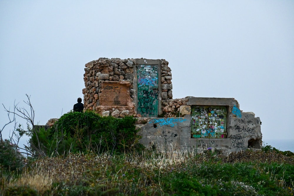 an old building with a broken door on top of a hill