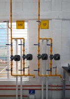 a room with pipes and a sign on the wall